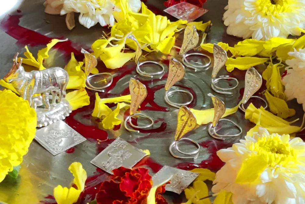 Silver naag pratima and flowers used in Kaal Sarp Dosh Nivaran Puja at Trimbakeshwar