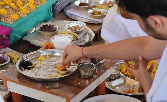 Pind daan and tarpan for ancestors with rice pinds, black til and flowers on a thali